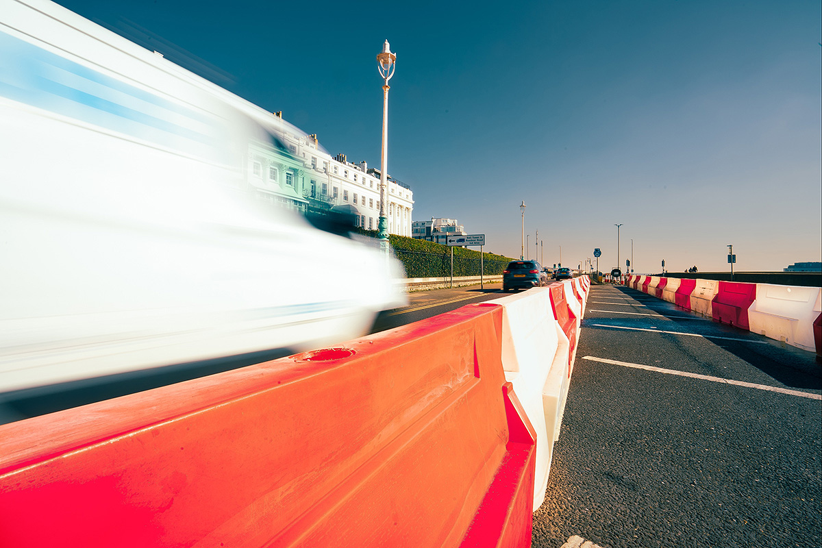road barriers with traffic blurred