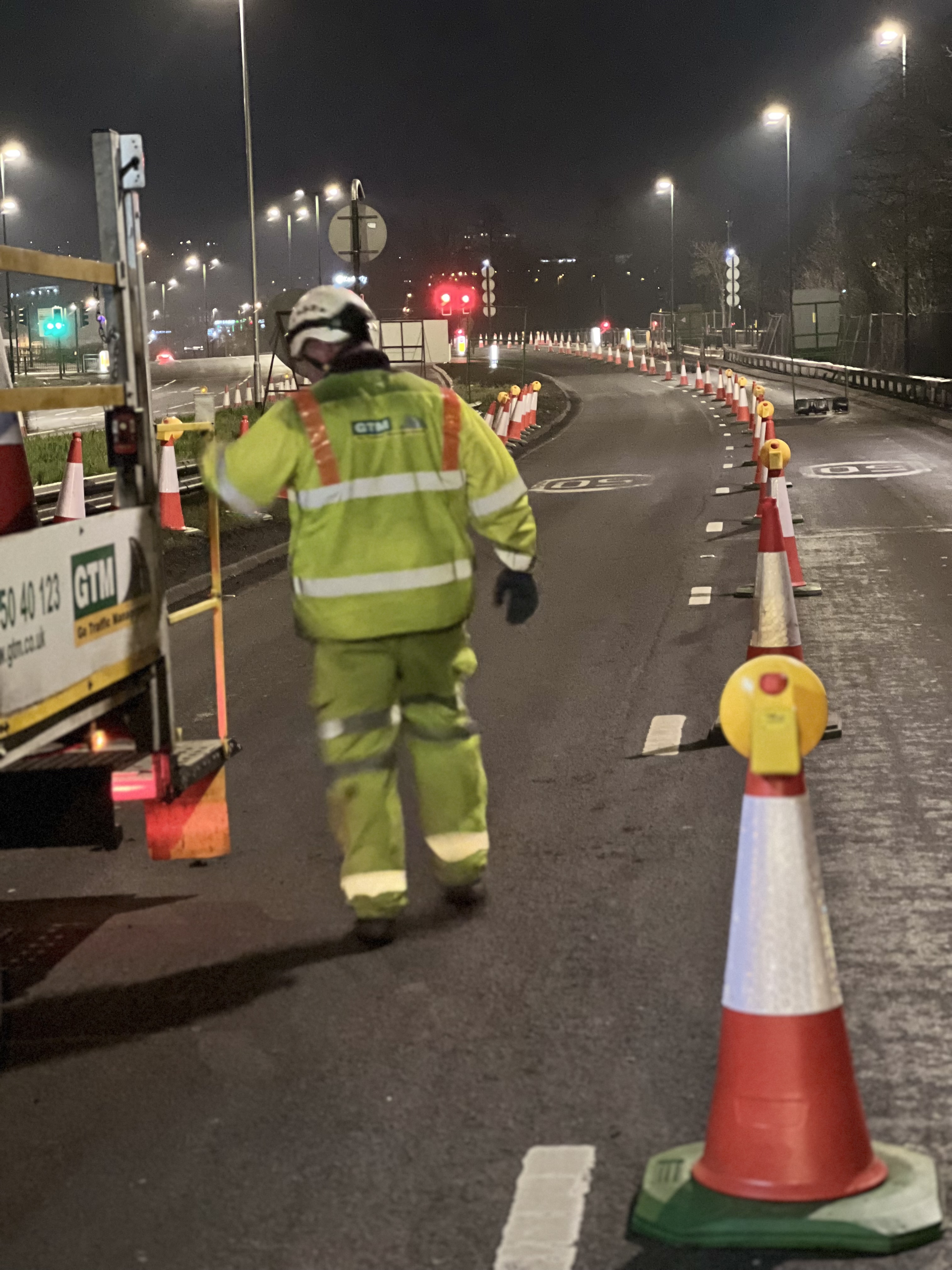 Operative at night on lane closure, in high vis